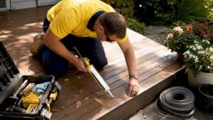 Tradesperson applying exterior building caulk