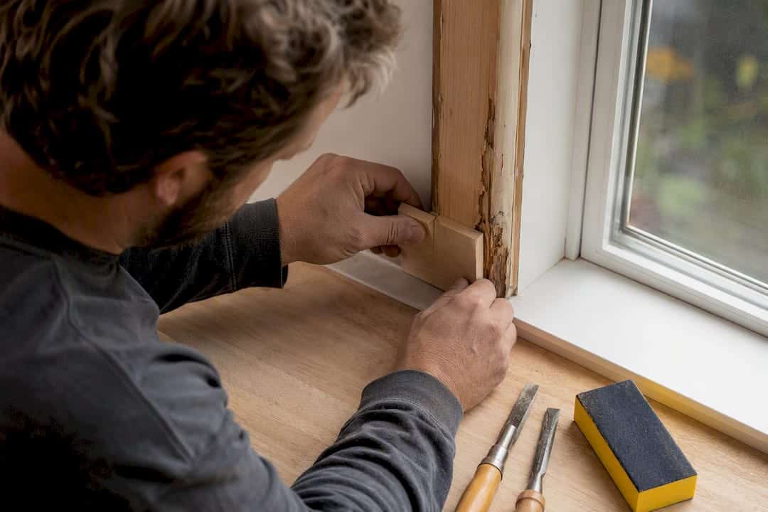 Carpenter fitting wood Dutchman patch