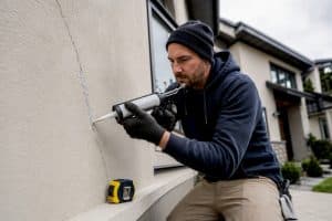 Specialist sealing crack in stucco wall