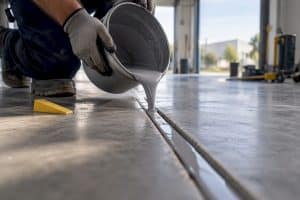 Self-leveling sealant poured into concrete joint