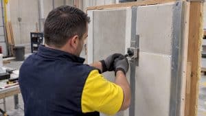Technician performing sealant adhesion pull test