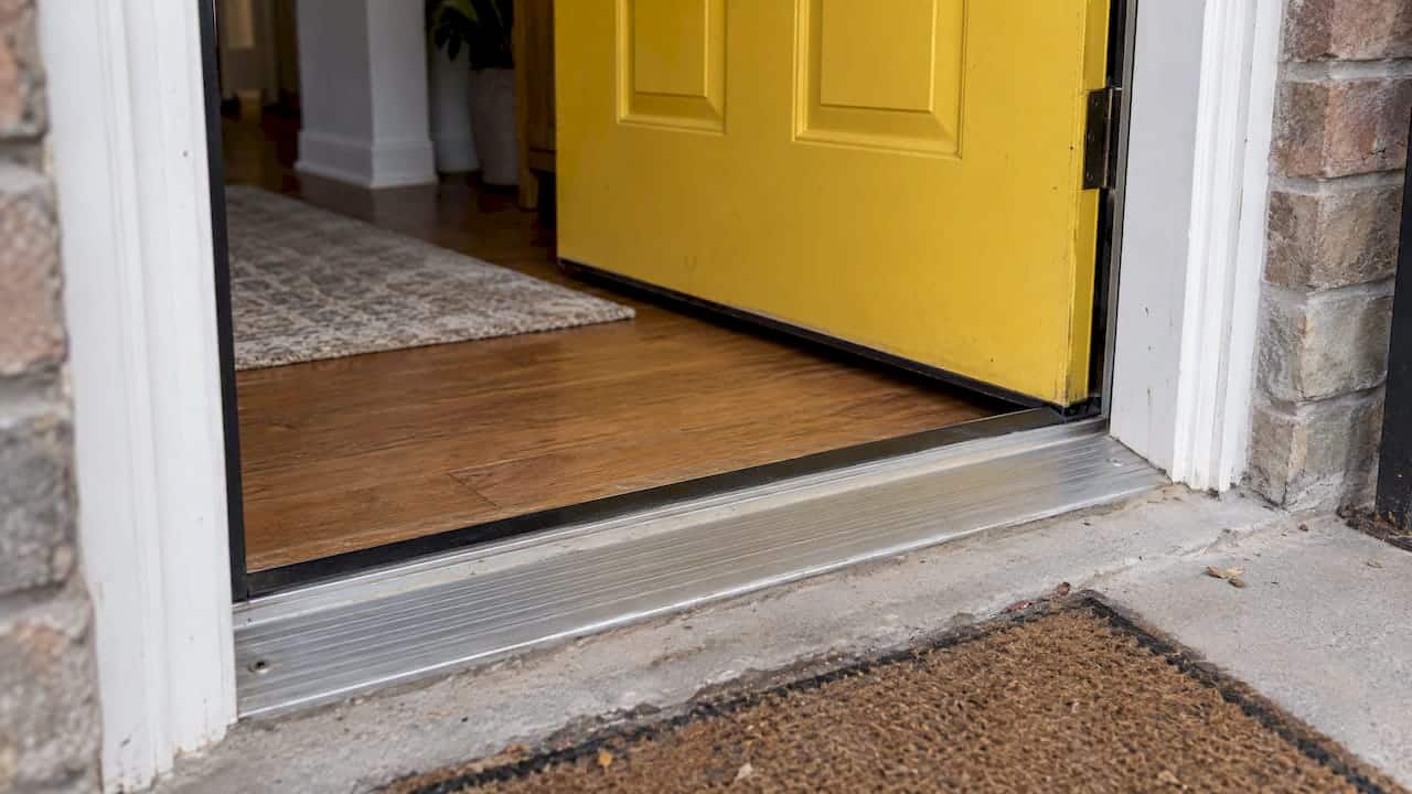 Exterior door and metal threshold at townhouse entry
